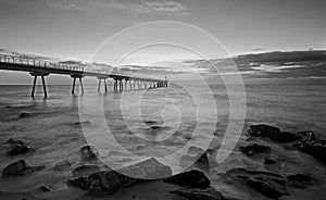 Sunrise on a bridge over the sea photo