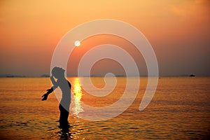 Sunrise cheering woman open arms