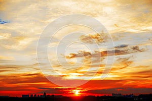 Sunrise in city landscape. Urban sunset. Rays of the sun above t