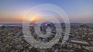 Sunrise with cityscape of Ajman from rooftop aerial timelapse. photo