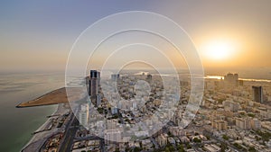 Sunrise with cityscape of Ajman from rooftop aerial timelapse. photo