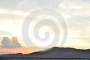 Sunrise clouds over mountain range and valley in Mojave Desert, USA