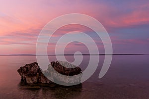 Sunrise Croatia Beach with Pastel Color and Rock in Foreground