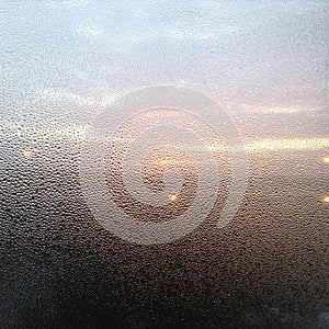 Sunrise through dewy window