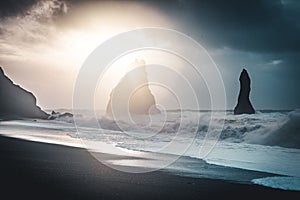 Sunrise at famous Black Sand Beach Reynisfjara in Iceland. Windy Morning. Ocean Waves. Colorful Sky. Morning Sunset.