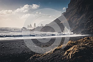 Sunrise at famous Black Sand Beach Reynisfjara in Iceland. Windy Morning. Ocean Waves. Colorful Sky. Morning Sunset.