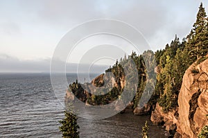 Sunrise famous Hopewell Rocks geologigal formations at low tide biggest tidal wave Fundy Bay New Brunswick Canada