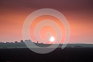 Sunrise in the field. Red sky at sunrise in the countryside_