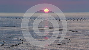 Sunrise and Fishing Nets on Sea Surface.