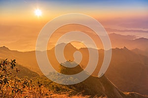 Sunrise with fog covered layers mountain hills in early morning from view point of Phu Chi Dao or Phu Chee Dao mountain at Chiang