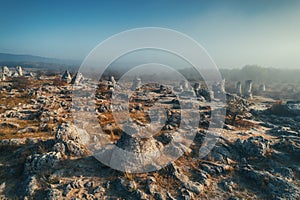 Sunrise fog over stone forest formation called pobiti kamani, landmark near Varna, Bulgaria