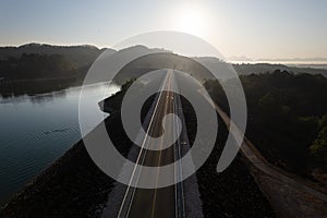 Sunrise and fog over straight road