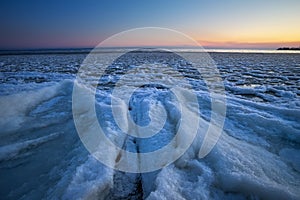 Sunrise and frozen river. Beautiful winter landscape with lake in morning time. Daybreak