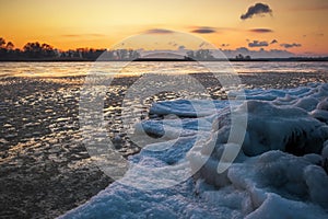 Sunrise and frozen river. Beautiful winter landscape with lake in morning time. Daybreak