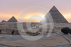 Sunrise in Giza: view on the Sphinx and the Pyramids