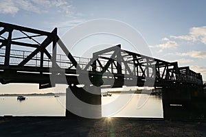 Sunrise glows through Tauranga Railway bridge silhouette