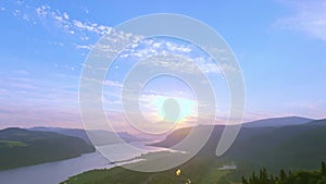 Sunrise golden hour aerial hovering above forest, tilt down revealing morning sun reflecting off the Columbia River & Vista House