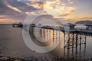 Sunrise golden light over Llandudno Pier in the Victorian seaside resort in North Wales