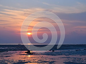 Sunrise with Golden Sun and its Reflection in Water and Colorful Sky - Vijaynagar Beach, Havelock Island, Andaman, India photo