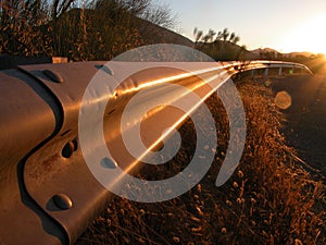 Sunrise on a guardrail