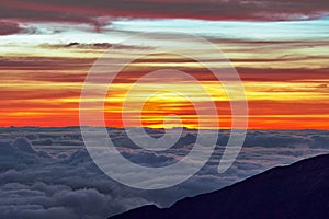 Sunrise at Haleakala Volcano with clouds and a colorful sky in Maui Hawaii