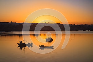 Sunrise in the harbour of Quellon in Chiloe Island, fishing boat