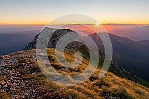 sunrise with haze from the Piatra Craiului mountain range in the Romanian Carpathians