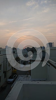 Sunrise, houses and DTH dish antenna