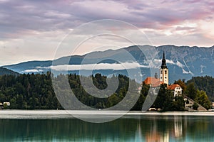 Sunrise at Lake Bled in Slovenia with Famous Church on Island. Water Reflections