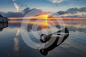 Sunrise on Lake Seliger with an old boat in the foreground.