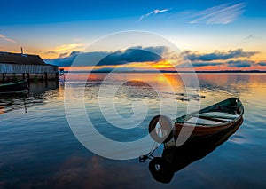 Sunrise on Lake Seliger with an old boat in the foreground.