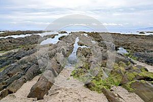 Sunrise landscape of ocean with waves clouds and rocks. Nature, sand. photo