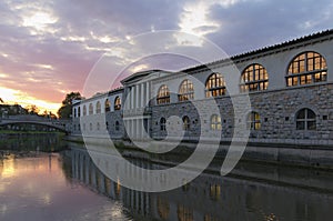 Sunrise landscape view of ancient city center of Ljubljana. Embankment of Ljubljanica River with colorful historic houses