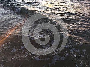 Sunrise Light on Pacific Ocean Waves on Beach in Kapaa on Kauai Island in Hawaii.