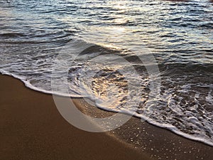 Sunrise Light on Pacific Ocean Waves on Beach in Kapaa on Kauai Island in Hawaii.