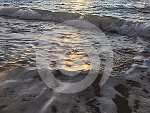 Sunrise Light on Pacific Ocean Waves on Beach in Kapaa on Kauai Island in Hawaii.