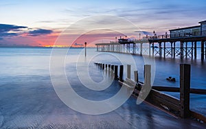 Sunrise in long time exposure of Grand Pier in Teignmouth in Devon