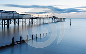 Sunrise in long time exposure of Grand Pier in Teignmouth in Devon