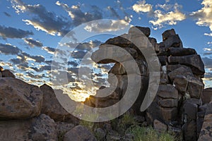 Sunrise and loose clouds at granite rocks