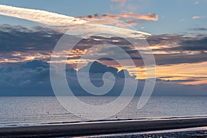 Sunrise with low clouds on Omaha Beach Normandy France