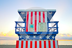 Sunrise in Miami Beach Florida, with a colorful American Flag lifeguard house