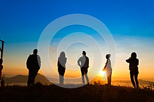 Sunrise on misty mountain with women and man