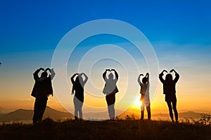 Sunrise on misty mountain with women and man