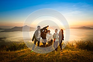 Sunrise on misty mountain with women and man