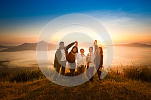 Sunrise on misty mountain with women and man