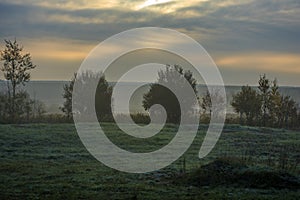 Sunrise and morning fog in autumn over a field