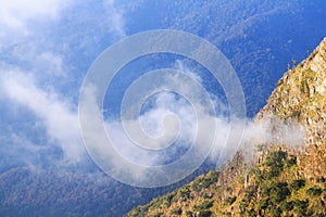 Sunrise in morning with sky and cloud on the Limestone mountain. Sunray with Fog and mist cover the jungle hill in Thailand