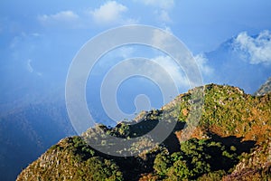 Sunrise in morning with sky and cloud on the Limestone mountain. Sunray with Fog and mist cover the jungle hill in Thailand