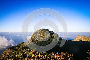 Sunrise in morning with sky and cloud on the Limestone mountain. Sunray with Fog and mist cover the jungle hill in Thailand