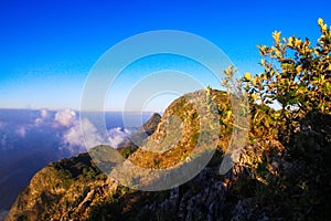 Sunrise in morning with sky and cloud on the mountain. Sunray with Fog and mist cover the jungle hill in Thailand